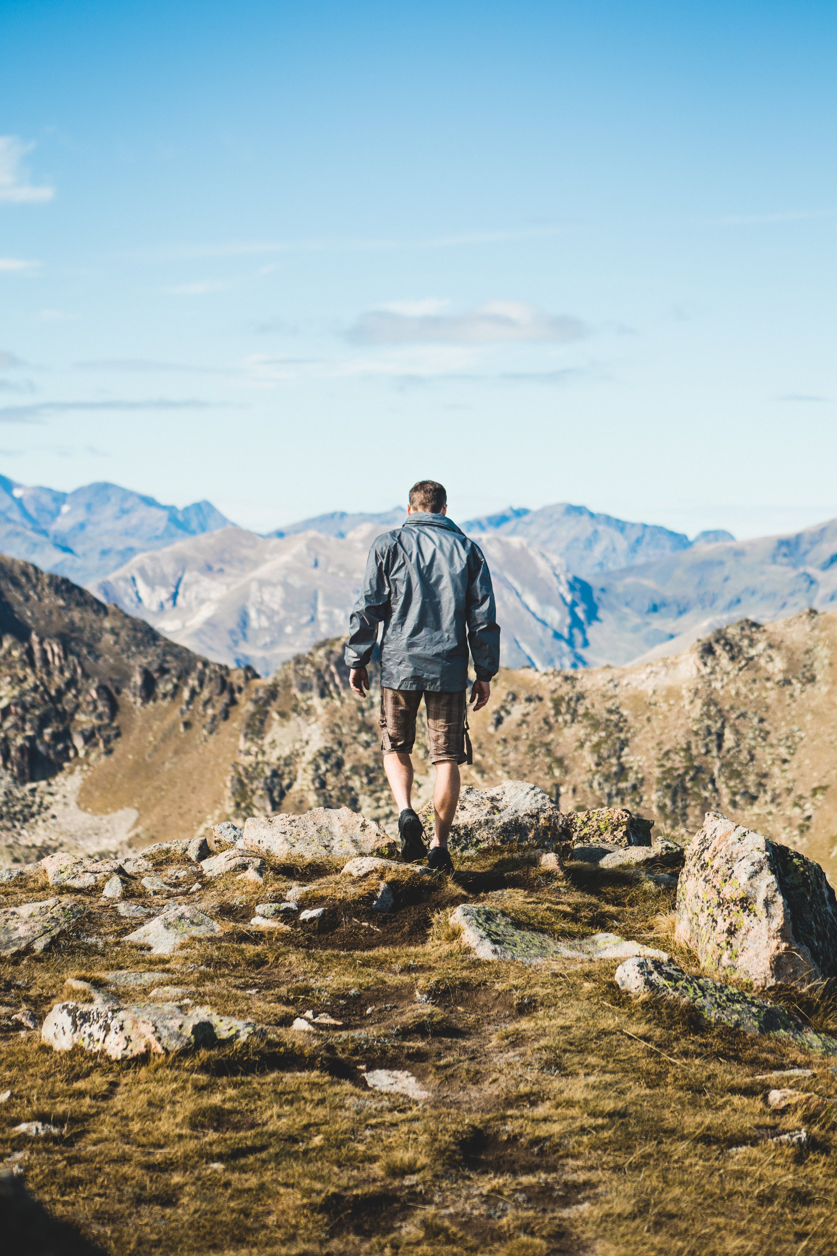 Man hiking in mountains, enjoying flake-free scalp after Epicderma natural relief