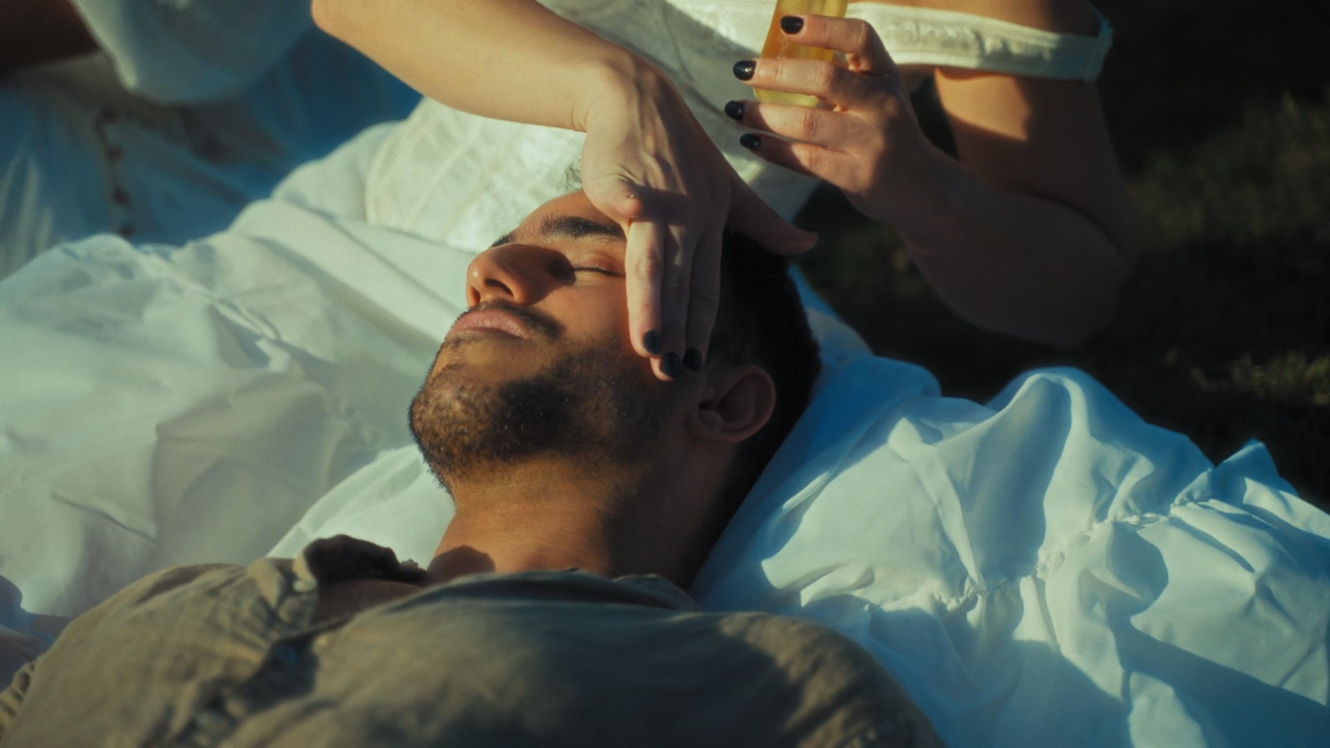 girl applying a product on a guy's skin