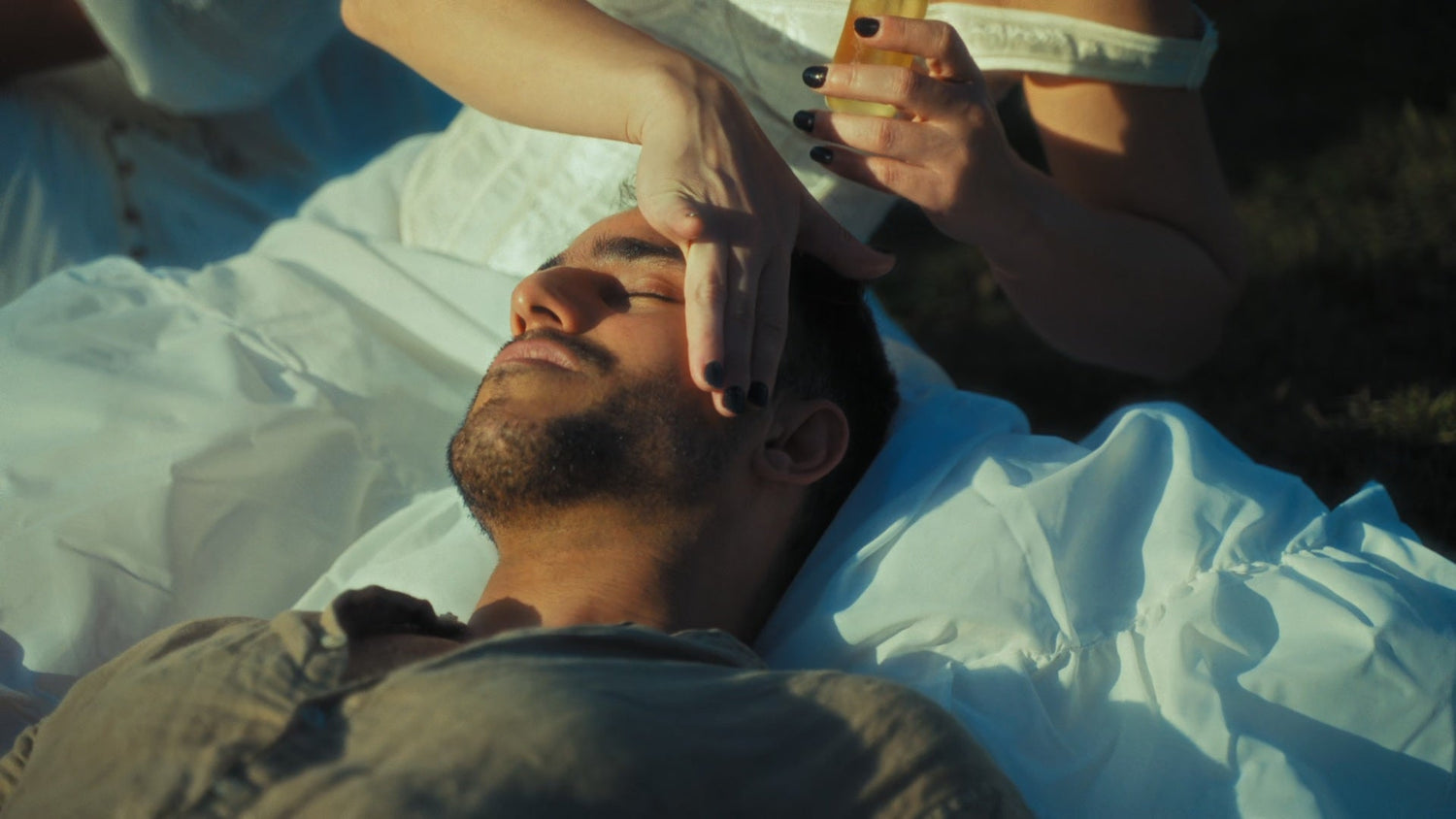 girl applying a product on a guy's skin