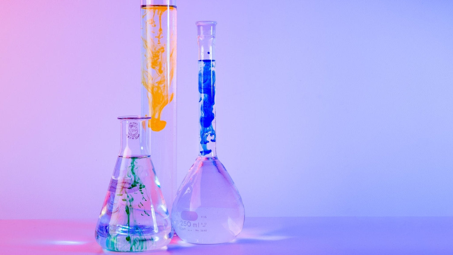 laboratory glassware filled with colorful liquids